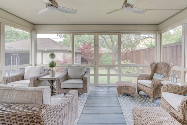 sunroom / solarium featuring ceiling fan and an outdoor hangout area