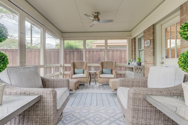 sunroom / solarium featuring plenty of natural light and ceiling fan