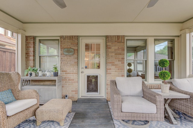 property entrance featuring covered porch, brick siding, and ceiling fan