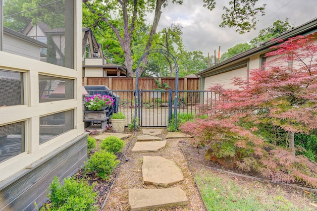 view of yard featuring a garage and fence