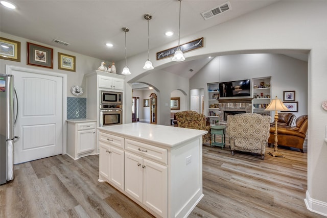 1314 Fleming Rd, Bells, TX 75414 - kitchen featuring appliances with stainless steel finishes, arched walkways, recessed lighting, light wood-type flooring, and visible vents