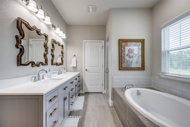 1314 Fleming Rd, Bells, TX 75414 - bathroom featuring a sink, baseboards, double vanity, and a bath