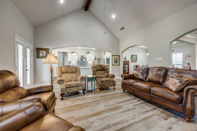 1314 Fleming Rd, Bells, TX 75414 - living room with visible vents, beamed ceiling, light wood-style floors, high vaulted ceiling, and arched walkways