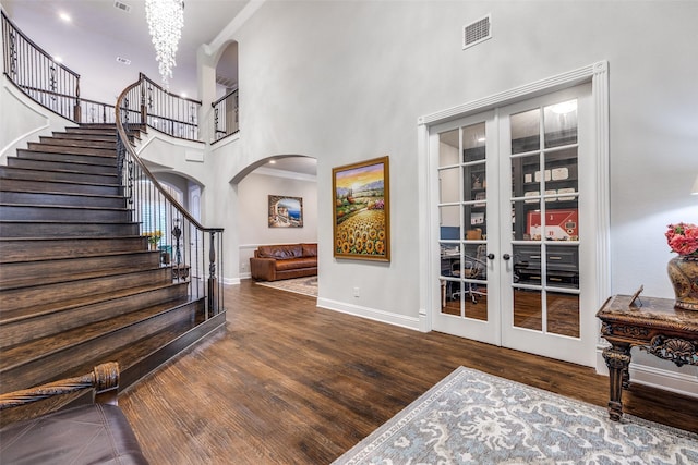 1110 Holford Dr, Frisco, TX 75036 - foyer entrance featuring visible vents, arched walkways, wood finished floors, a high ceiling, and stairs