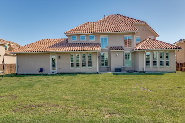 1110 Holford Dr, Frisco, TX 75036 - rear view of property featuring fence, central AC, a yard, stucco siding, and a tiled roof