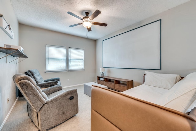 cinema room with baseboards, a ceiling fan, carpet flooring, and a textured ceiling