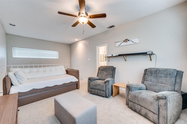 living room featuring a ceiling fan, carpet flooring, and visible vents