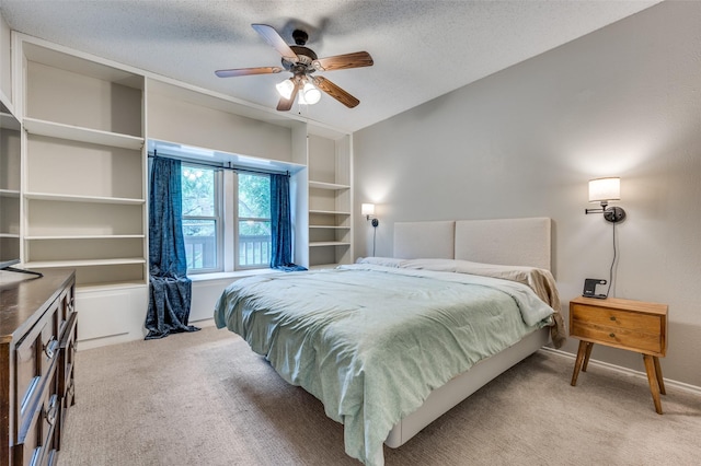 bedroom featuring carpet floors, a ceiling fan, a textured ceiling, and baseboards