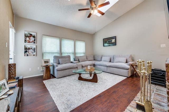 living area with dark wood-type flooring, baseboards, ceiling fan, and lofted ceiling