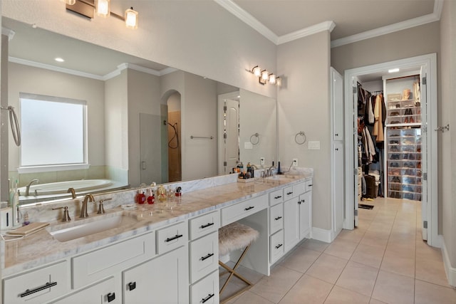 full bath with double vanity, a bath, tile patterned floors, a sink, and a stall shower