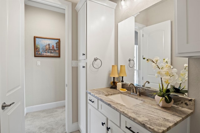 bathroom with baseboards and vanity