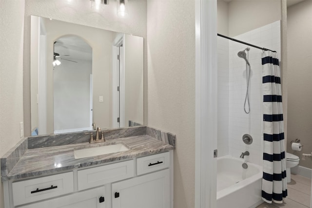 full bath featuring ceiling fan, shower / bath combination with curtain, vanity, tile patterned floors, and toilet