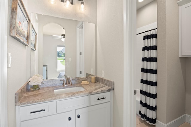 bathroom featuring a ceiling fan, curtained shower, and vanity
