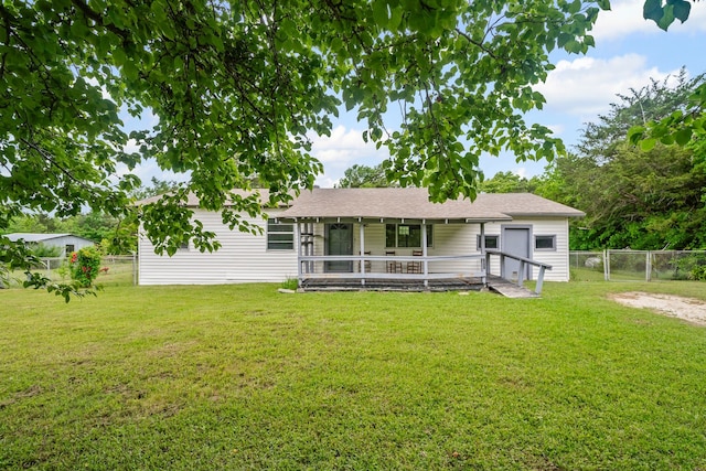 back of house with fence, a sunroom, a gate, and a lawn