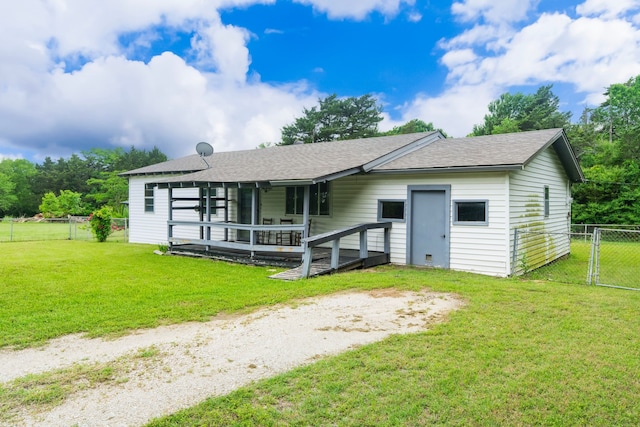 view of front of property featuring fence, a gate, roof with shingles, and a front lawn