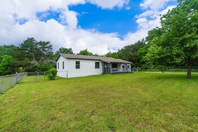 rear view of property with a lawn and a fenced backyard
