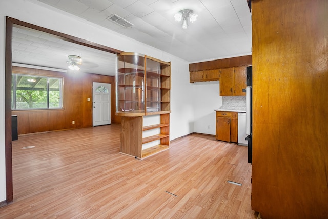 kitchen with decorative backsplash, visible vents, open shelves, brown cabinets, and light wood-style floors