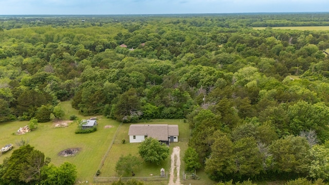 birds eye view of property with a forest view