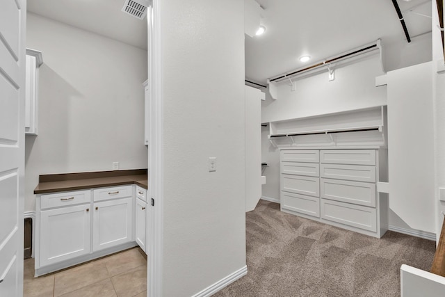 walk in closet featuring visible vents and light tile patterned floors