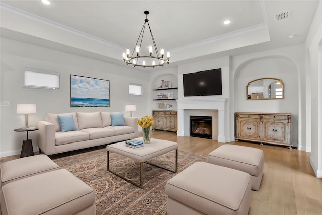 1844 Quiet Oak Pl, Fort Worth, TX 76008 - living room with a chandelier, wood finished floors, a glass covered fireplace, ornamental molding, and recessed lighting