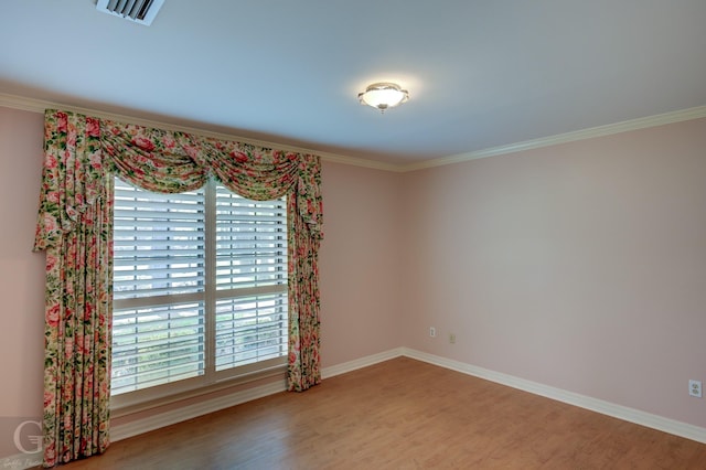 5030 Old Mooringsport Rd, Shreveport, LA 71107 - spare room featuring baseboards, visible vents, ornamental molding, and wood finished floors