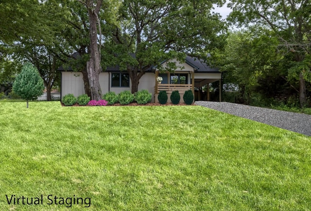 328 Whispering Trl, Gun Barrel City, TX 75156 - view of front of house with a front yard, gravel driveway, and a carport