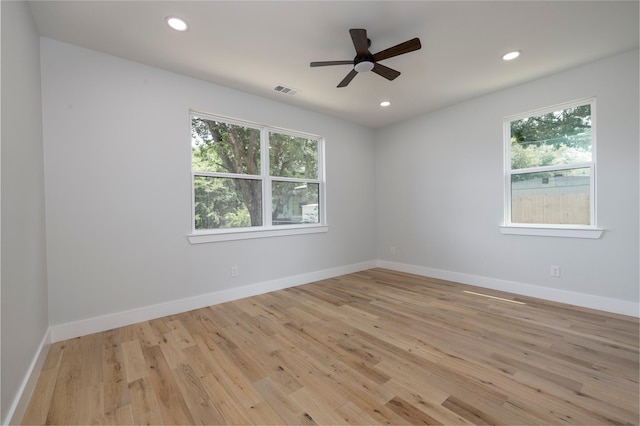 unfurnished room featuring recessed lighting, light wood-style flooring, and baseboards