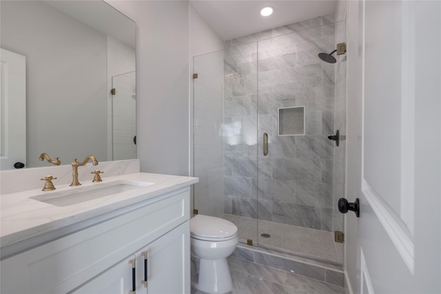 bathroom featuring vanity, toilet, marble finish floor, recessed lighting, and a stall shower