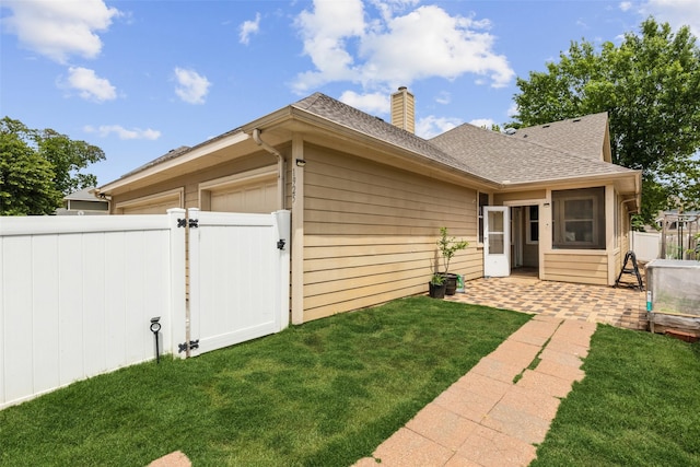1925 Bridgeport Dr, Providence Village, TX 76227 - rear view of house featuring fence, a chimney, a gate, a shingled roof, and a patio area