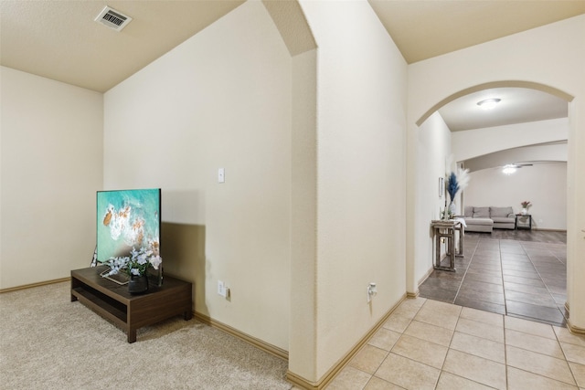 1925 Bridgeport Dr, Providence Village, TX 76227 - corridor featuring light tile patterned floors, arched walkways, and visible vents