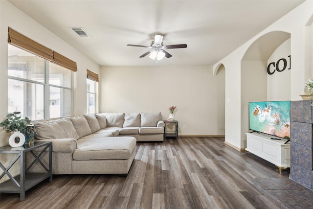 1925 Bridgeport Dr, Providence Village, TX 76227 - living room with a ceiling fan, visible vents, arched walkways, baseboards, and dark wood-type flooring