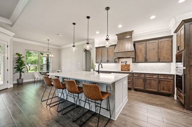 317 Wayward Spur, Springtown, TX 76082 - kitchen with custom range hood, stainless steel appliances, a sink, light countertops, and decorative backsplash