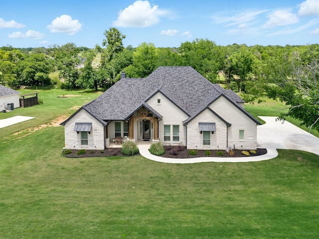 317 Wayward Spur, Springtown, TX 76082 - view of front facade featuring a front lawn, stone siding, a chimney, and roof with shingles
