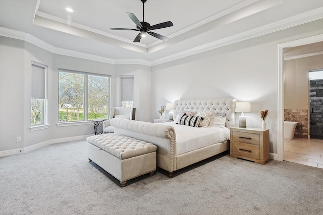 bedroom featuring ornamental molding, a tray ceiling, and light carpet