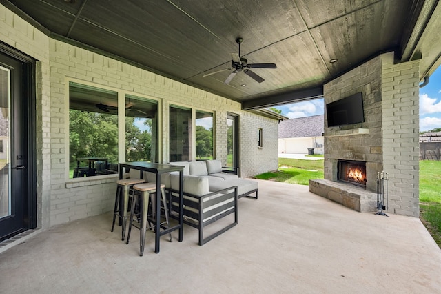 317 Wayward Spur, Springtown, TX 76082 - view of patio / terrace featuring ceiling fan and an outdoor living space with a fireplace