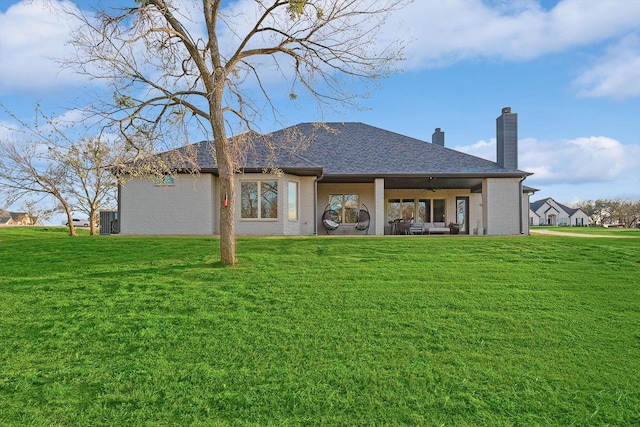 back of property featuring central AC, ceiling fan, a chimney, a lawn, and a patio