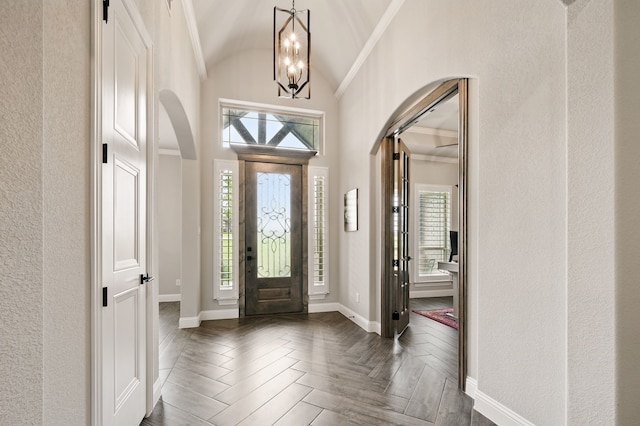 317 Wayward Spur, Springtown, TX 76082 - foyer entrance with arched walkways, a chandelier, baseboards, and vaulted ceiling