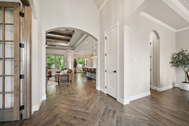 317 Wayward Spur, Springtown, TX 76082 - foyer entrance with arched walkways, ceiling fan, baseboards, crown molding, and a tray ceiling
