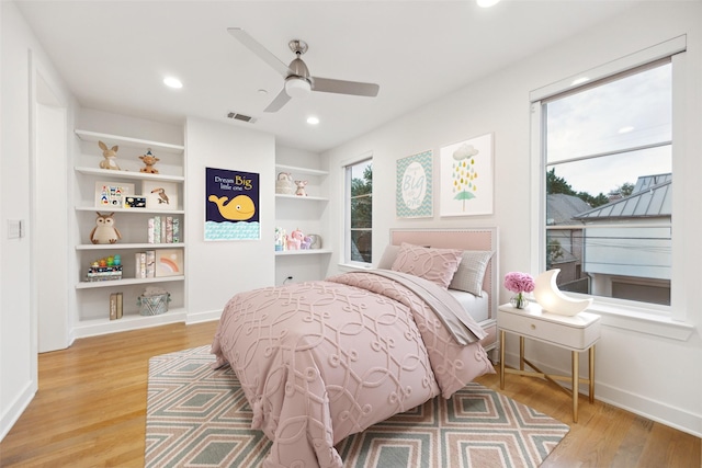 bedroom with a ceiling fan, visible vents, baseboards, light wood-style floors, and recessed lighting