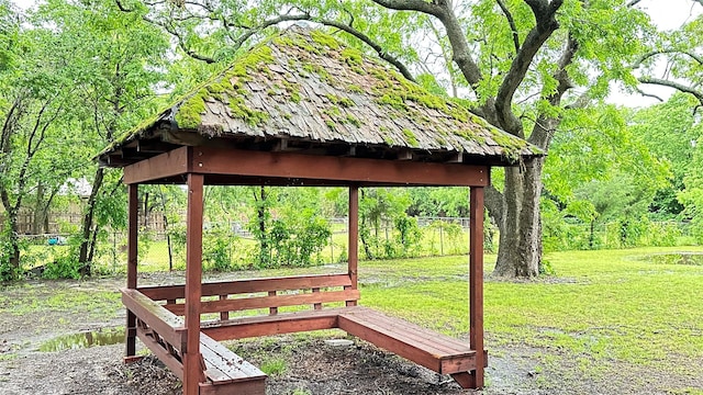 view of community with a lawn and fence