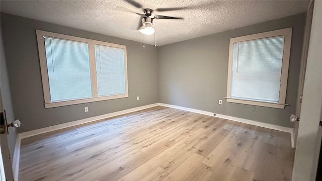 spare room with baseboards, a textured ceiling, ceiling fan, and wood finished floors