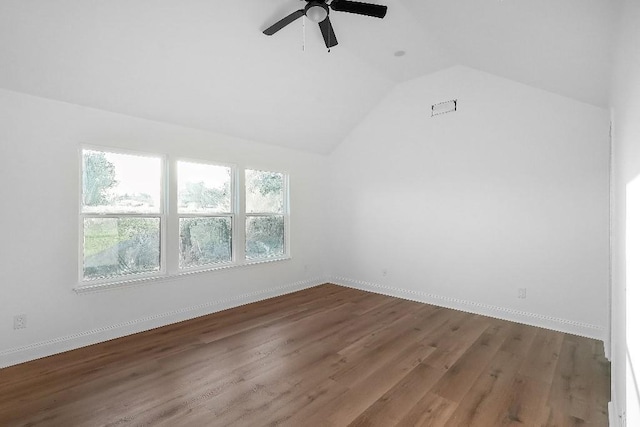 additional living space featuring ceiling fan, baseboards, wood finished floors, lofted ceiling, and visible vents