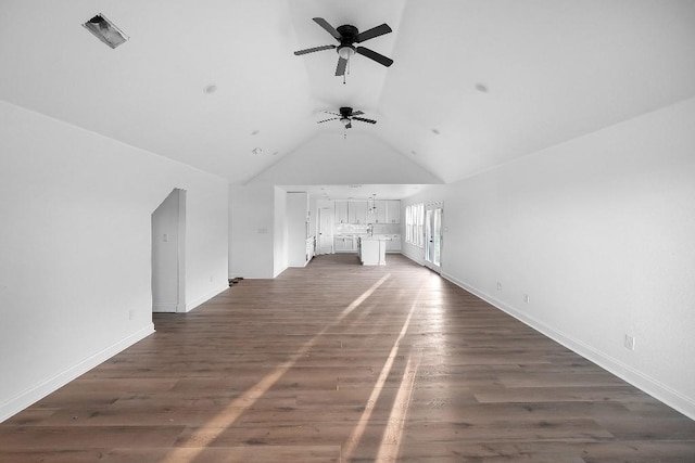unfurnished living room featuring baseboards, a ceiling fan, dark wood-style floors, and lofted ceiling