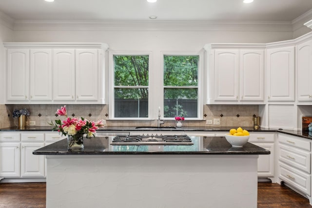 kitchen featuring a sink, white cabinetry, stainless steel gas cooktop, and a kitchen island