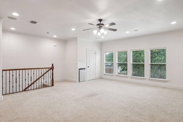 spare room with crown molding, a ceiling fan, recessed lighting, and light colored carpet