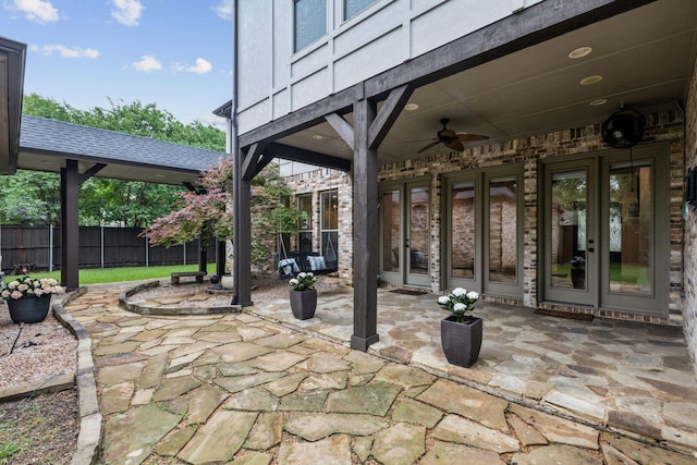 view of patio / terrace featuring fence, a ceiling fan, and french doors
