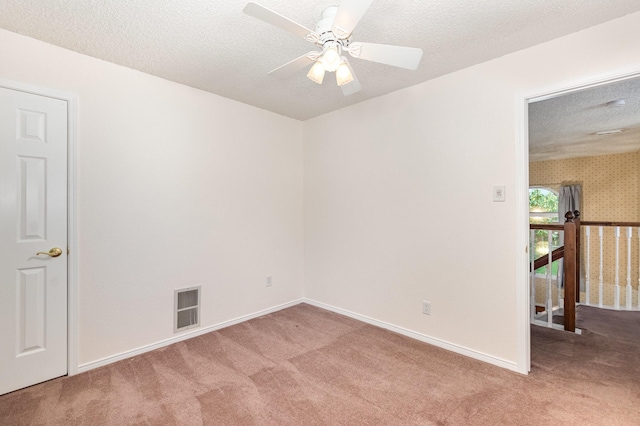 7208 Stoddard Ln, Plano, TX 75025 - carpeted empty room with visible vents, a textured ceiling, ceiling fan, and baseboards