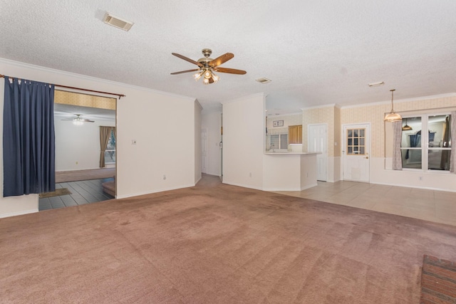 7208 Stoddard Ln, Plano, TX 75025 - unfurnished living room with carpet flooring, a textured ceiling, a ceiling fan, visible vents, and ornamental molding