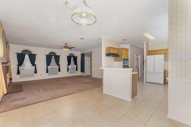 7208 Stoddard Ln, Plano, TX 75025 - kitchen featuring a ceiling fan, built in microwave, light tile patterned floors, freestanding refrigerator, and under cabinet range hood