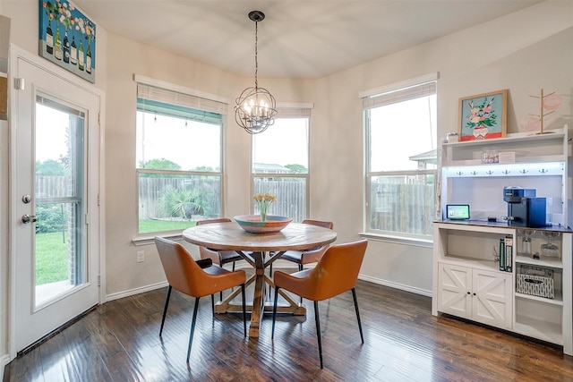 dining area with baseboards, a notable chandelier, and dark wood-style floors